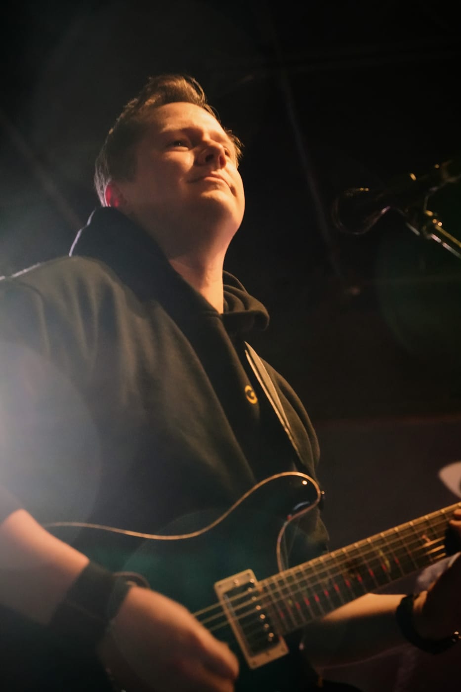 Guitarist on stage, warm lighting